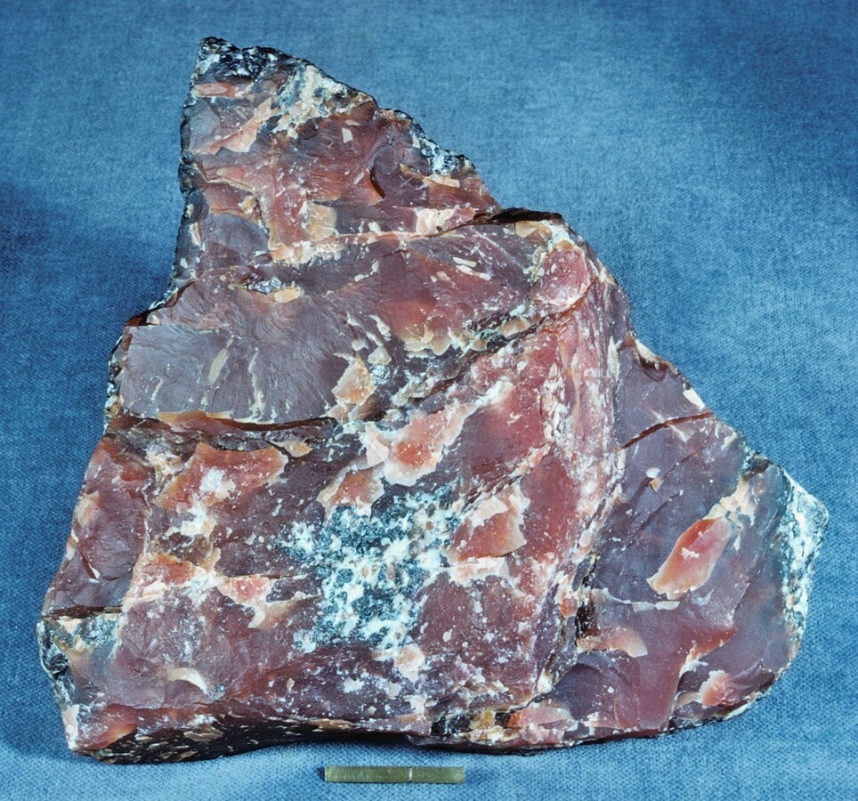 Massive brownish-red Friedelite specimen showing a granular texture and waxy luster.