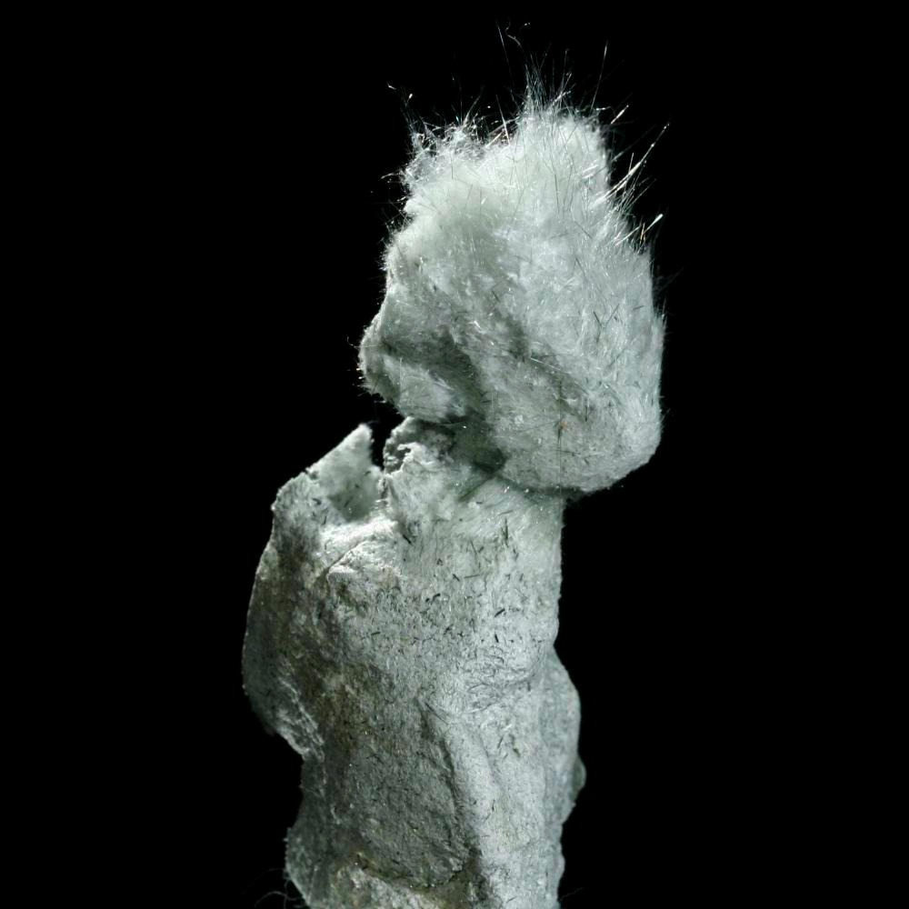 Fibrous asbestiform actinolite mineral specimen showing a soft, white cotton-like texture with fine silicate fibers.