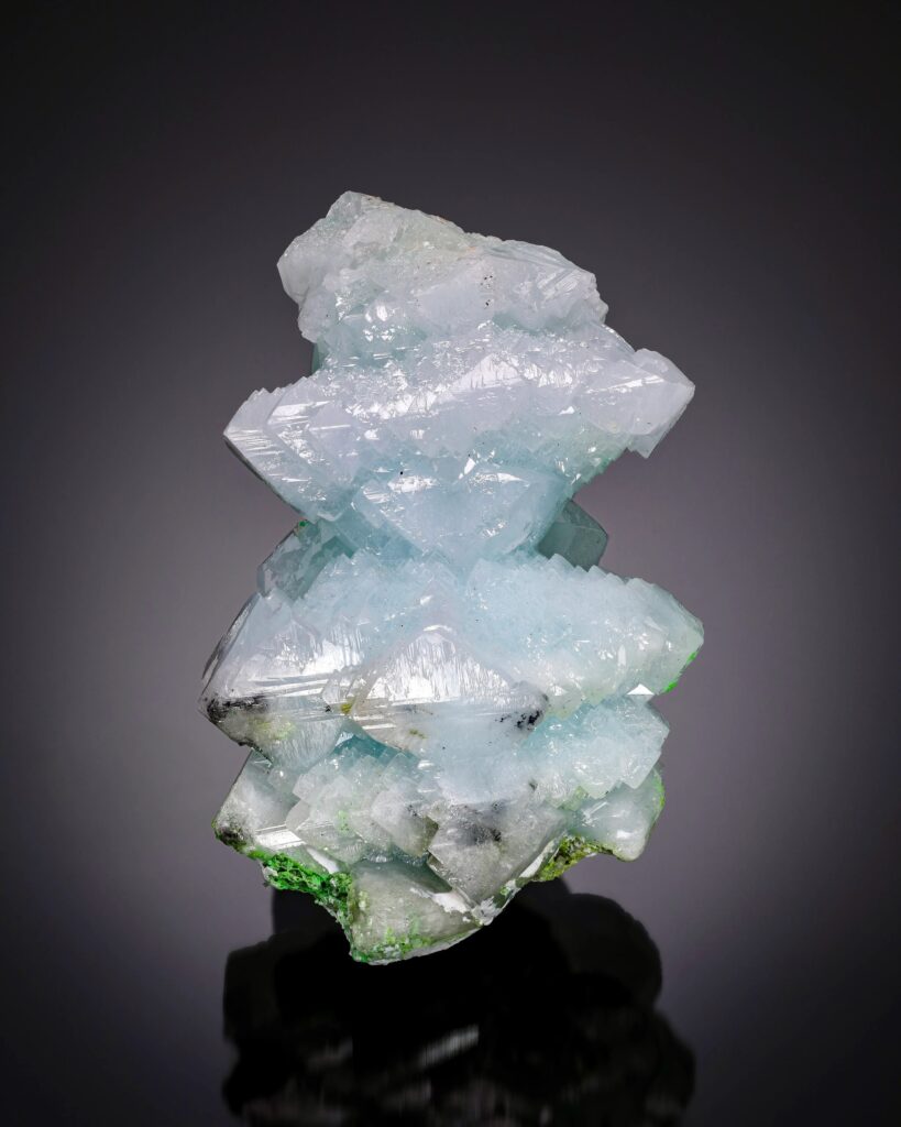 A rare, pale icy-blue crystalline cluster of Anglesite from the Tsumeb Mine in Namibia. The specimen features complex, intersecting tabular crystals with a vitreous luster, showcasing one of the mineral's most sought-after color variations.
