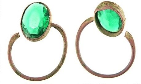 A post-medieval to early 1800s finger ring featuring a faceted green glass paste stone.