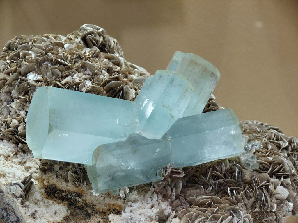 Raw aquamarine crystals on a mineral matrix