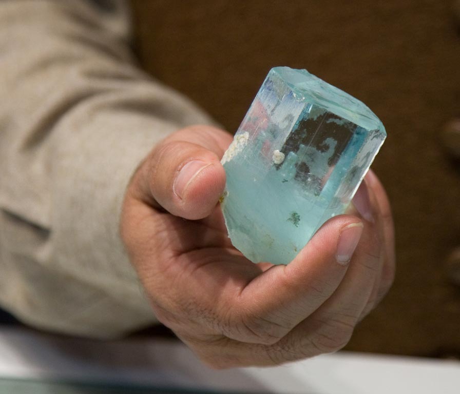 Close-up of a rough, untreated aquamarine crystal showcasing its raw beauty and clarity