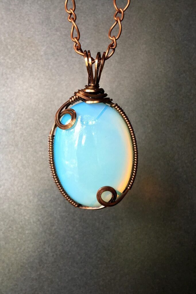 Opalite, like the oval shown in this pendant, is a glass material frequently used to simulate moonstone.