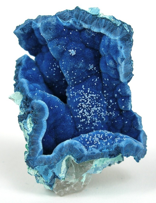 Shattuckite, from Kandesei, Opuwo Rural, Kunene Region, Namibia. This 4.4 x 3.0 x 1.7 cm specimen features a nice pocket in massive shattuckite, containing sparkling, acicular shattuckite crystals that form a carpet over rolling hills of massive shattuckite matrix. It is a beautiful miniature with superb color and sparkle, interestingly decorated with a light dusting of sub-millimeter specks that appear to be chrysocolla.