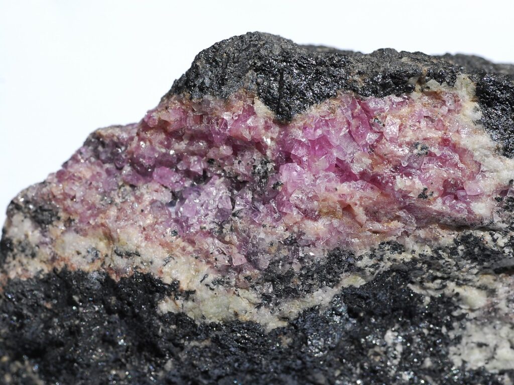 Hodgkinsonite, Franklinite, Willemite Franklin Mine, Franklin, Sussex County, New Jersey, USA Purple hodgkinsonite forming a crude vein in the willemite/franklinite ore.